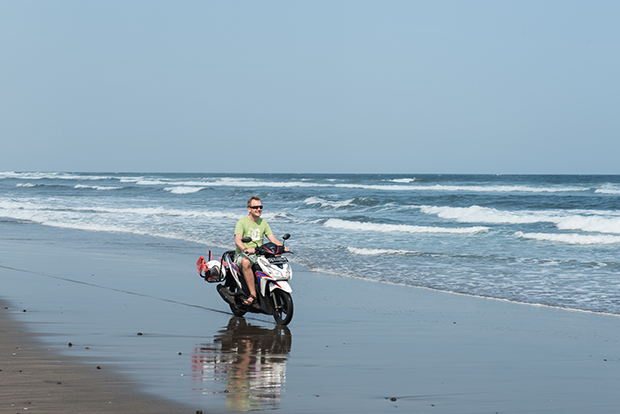 Riding a motorbike on the beach feels really good.